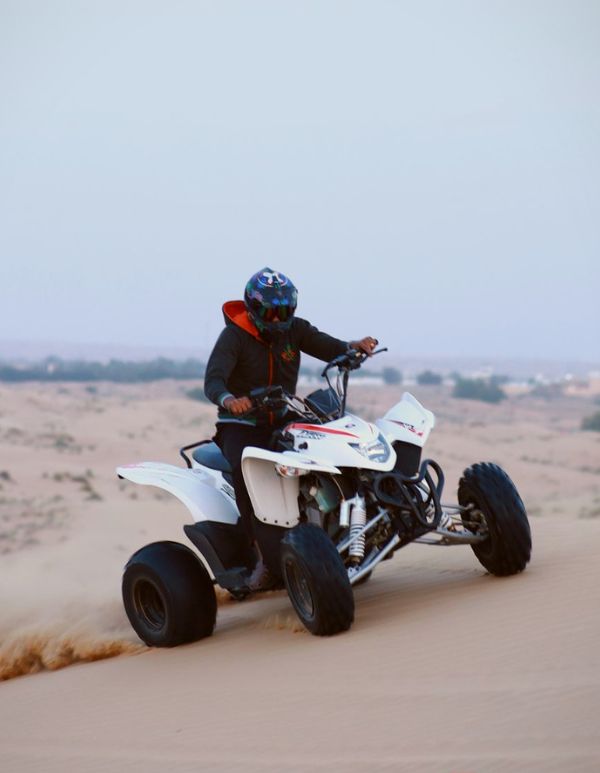 man riding a quad bike